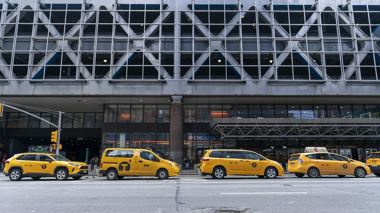 Yellow cabs line-up along 8th Ave outside Port Authority Bus Terminal, Friday, Jan. 22, 2021, in New York. The Port Authority of New York and New Jersey unveiled a proposal Thursday, Jan. 21, to rebuild and expand the embattled midtown Manhattan bus terminal. (AP Photo/Mary Altaffer)